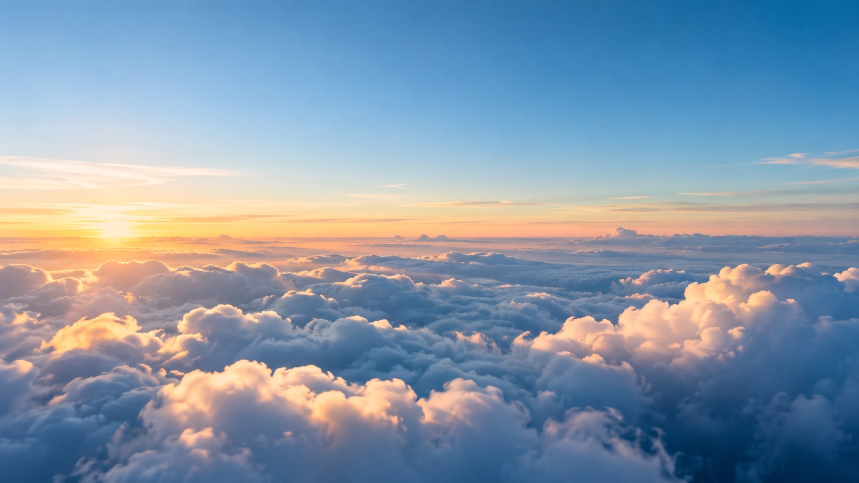 Sunlight spilling across an open sea of clouds